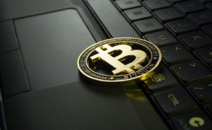 Crypto coin laying on the laptop keyboard