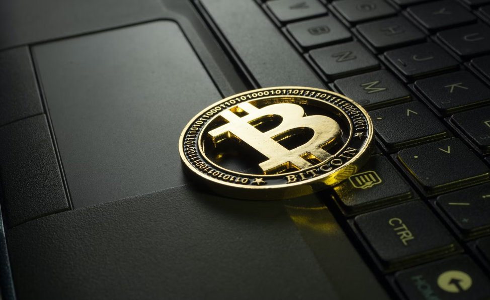 Crypto coin laying on the laptop keyboard