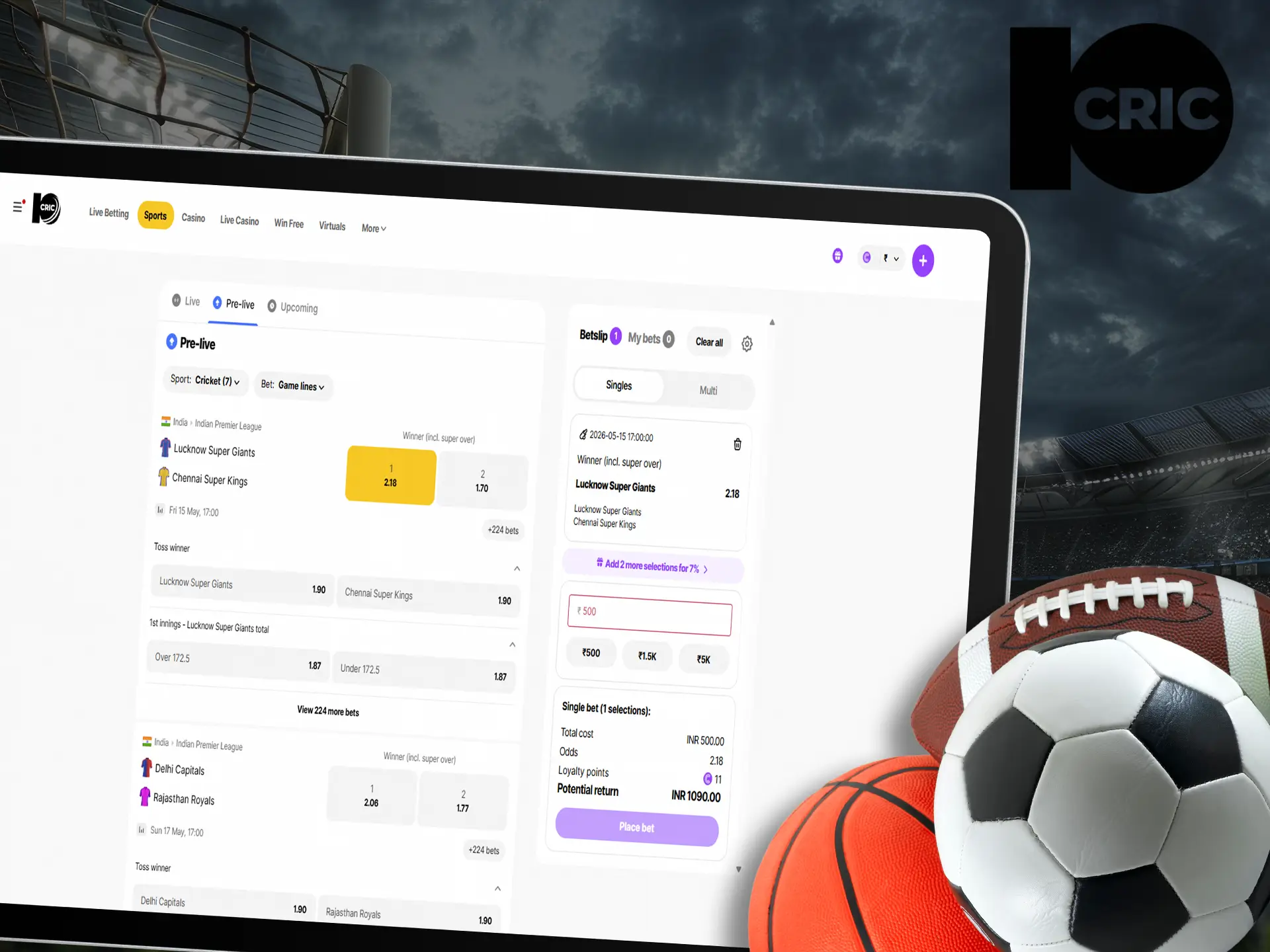 Tablet displaying sports betting website with various sports balls around.